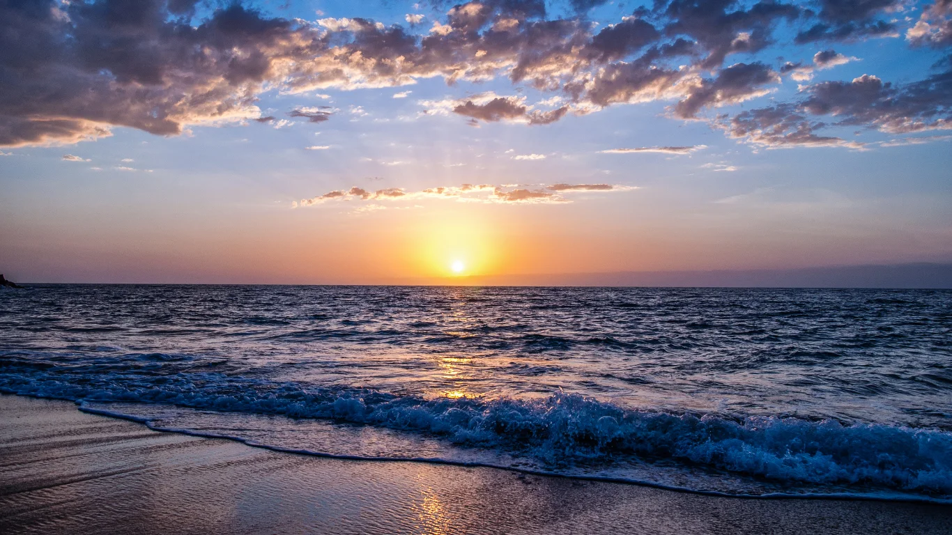 Sunset over the ocean waves on the Mare in Marocco coastline