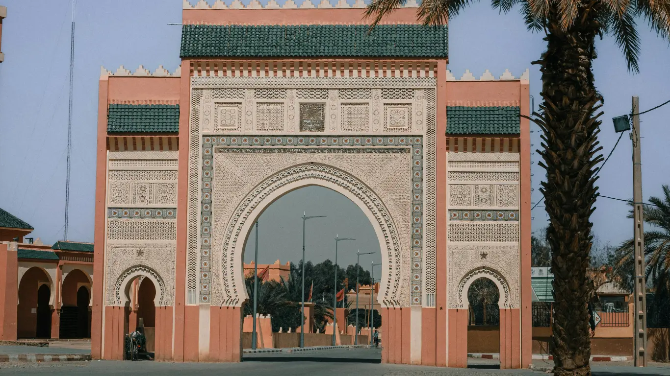The ornate main gate of Rissani, Morocco, with traditional Moorish architecture, often visited during a 3-day tour from Marrakech to Merzouga.