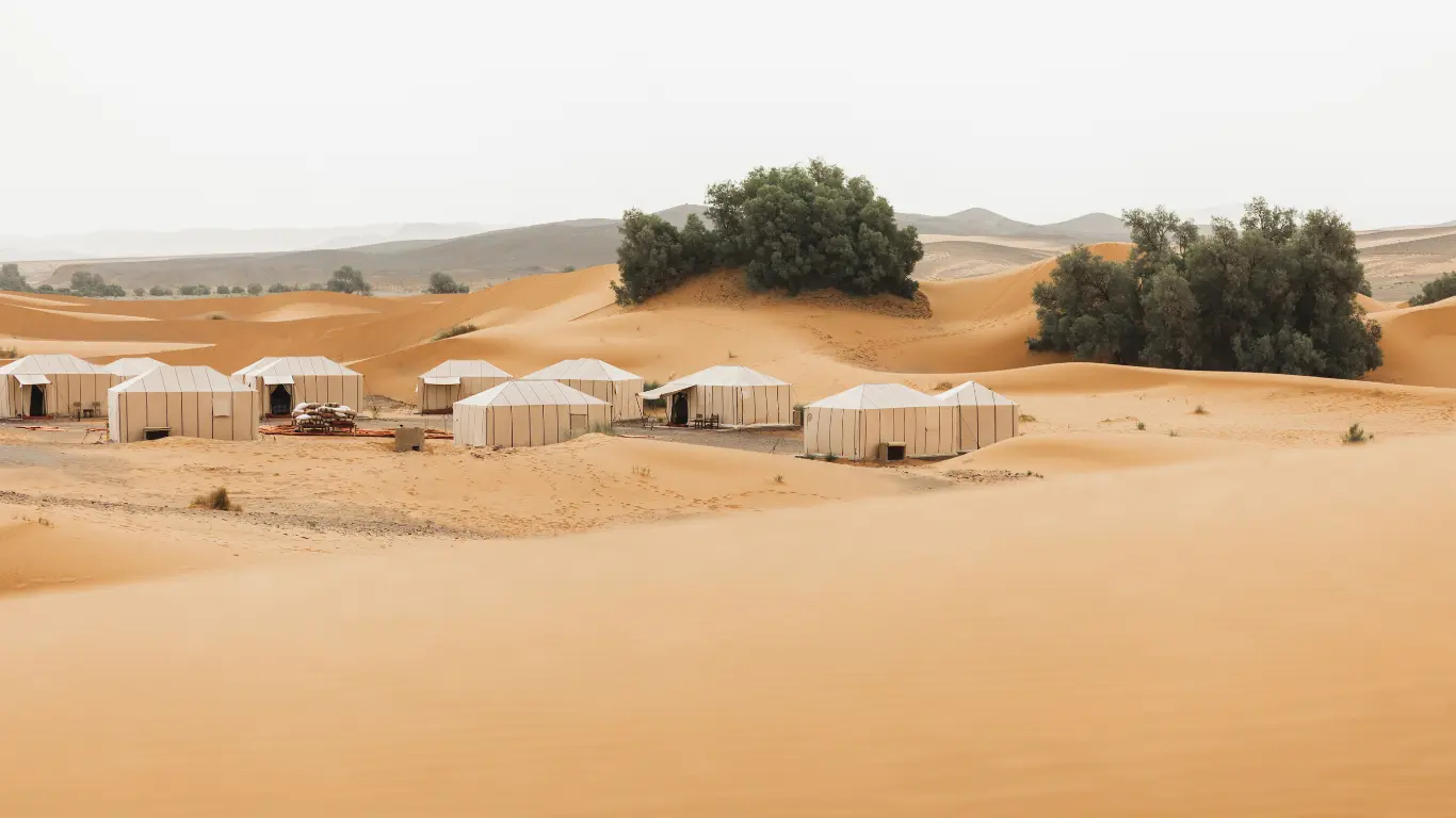 Luxury desert camp in Merzouga surrounded by golden dunes – part of a 4 days tour from Marrakech to Merzouga desert