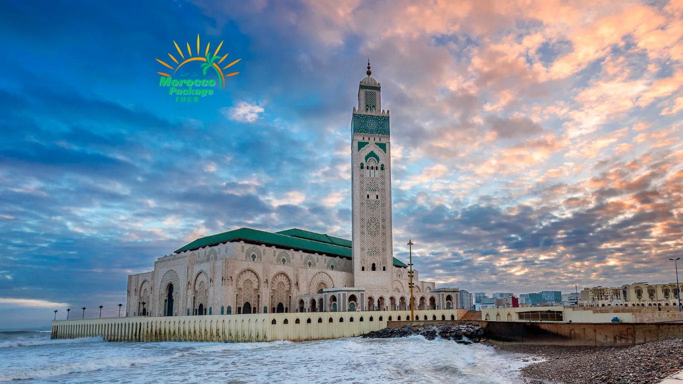 Hassan II Mosque in Casablanca at sunset with waves crashing along the shore – a highlight of 2 weeks in Morocco.