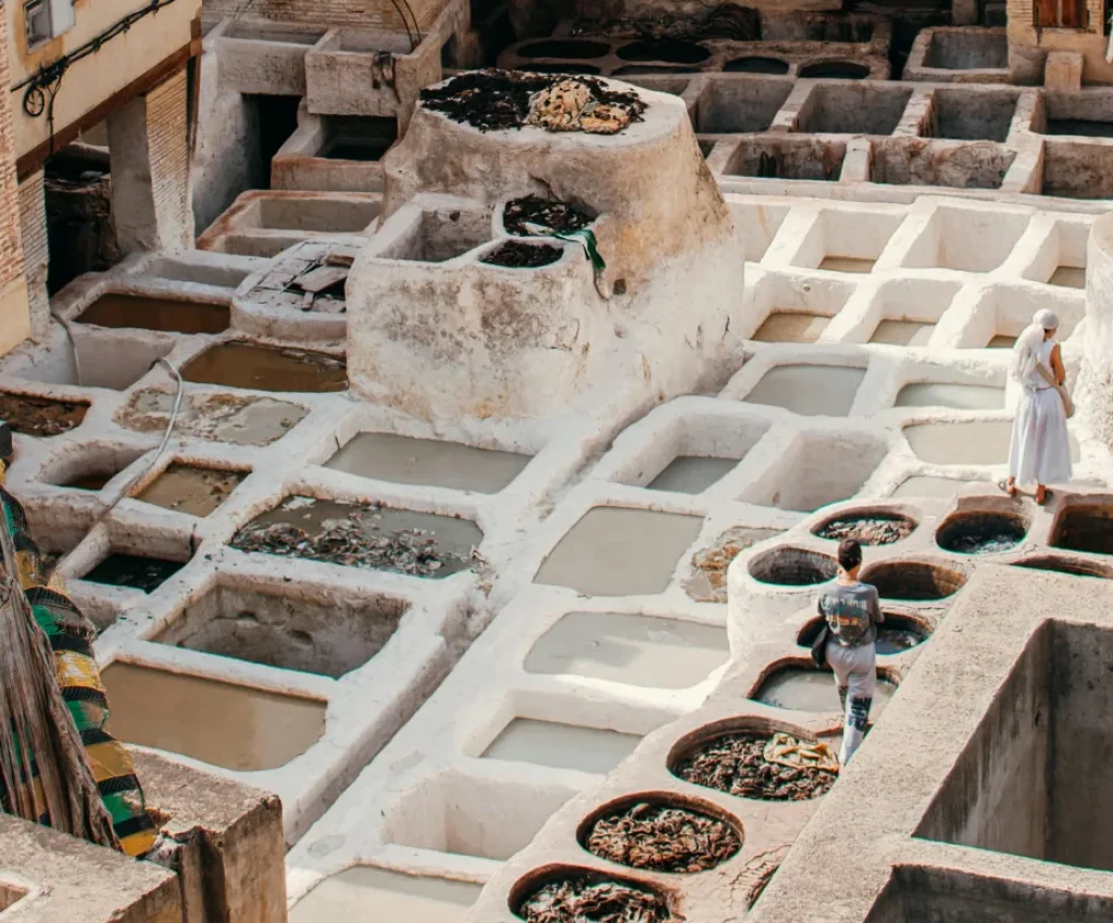 Chouara Tannery in Fes – Start of the 3 Days Tour from Fes to Marrakech Two tourists explore the ancient Chouara Tannery in Fes, Morocco, during a 3 days tour from Fes to Marrakech.