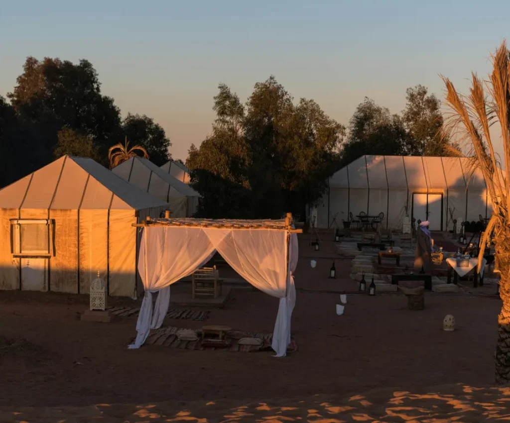 Traditional luxury desert camp at sunset in Merzouga during a 4 days tour from Marrakech.