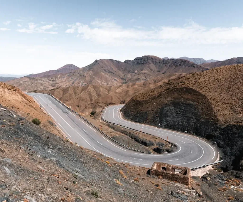 Winding mountain road at Tizi n'Tichka Pass, a highlight of a 4-day itinerary from Marrakech through the High Atlas Mountains.